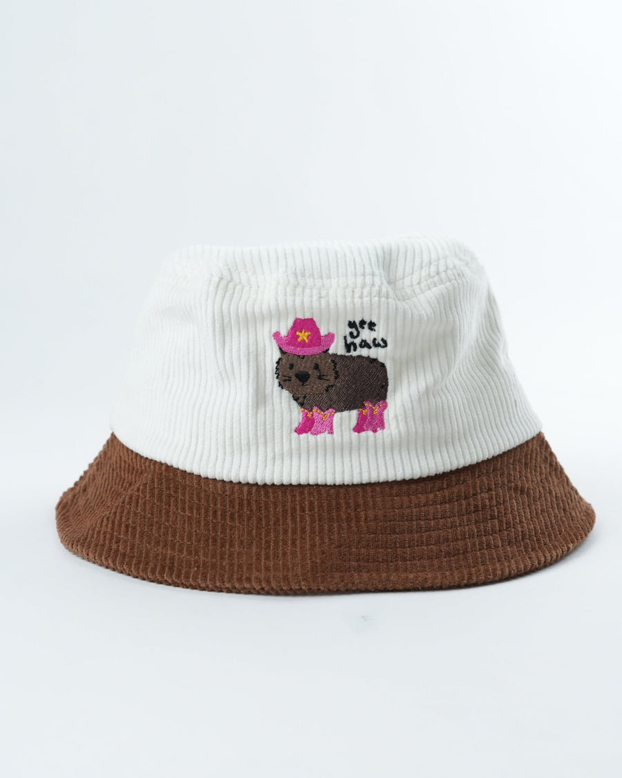 Two-tone bucket hat with white knit crown, brown brim, and pink cartoon animal patch