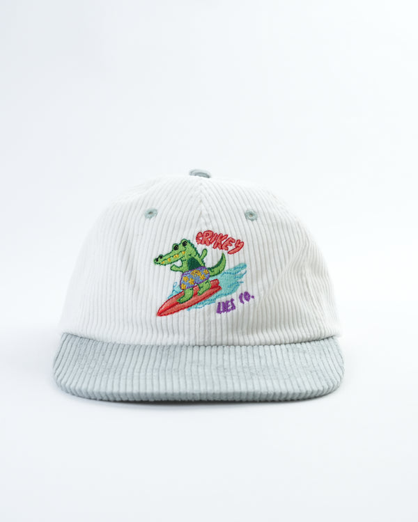 Light gray corduroy hat with embroidered gator surfing graphic on the front.