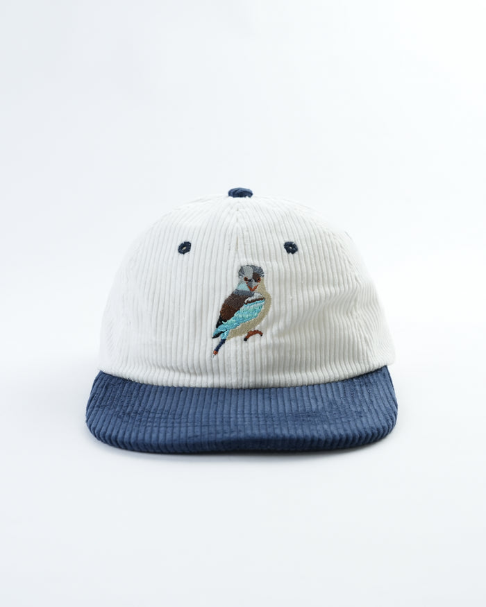 Vintage kookaburra cap, front view: white ribbed crown with navy dots and bird emblem