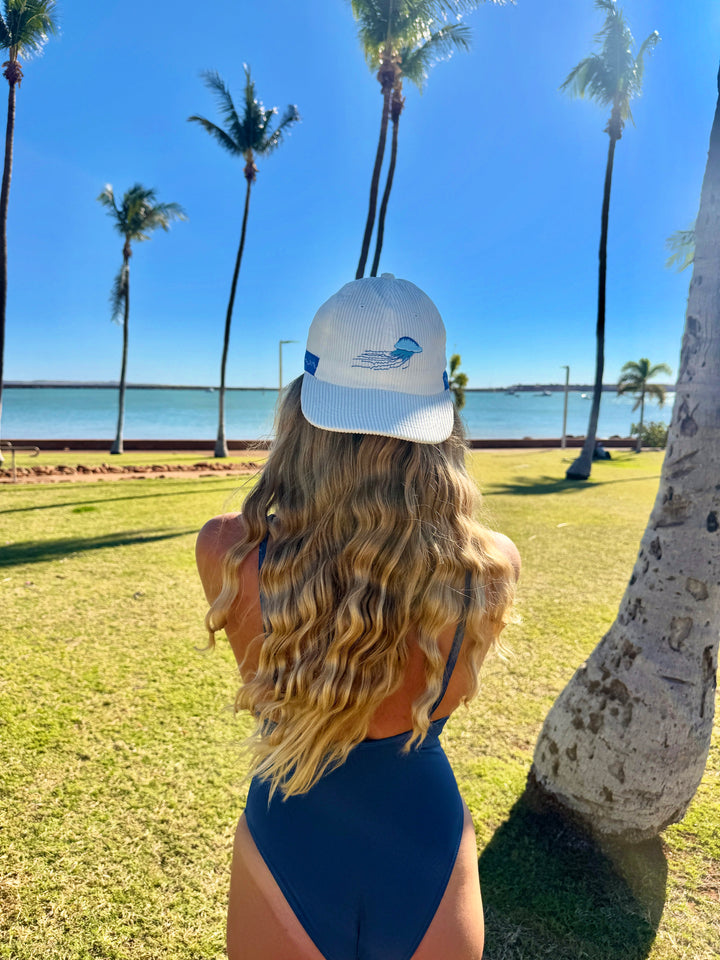 Light gray baseball cap with front logo patch and curved brim