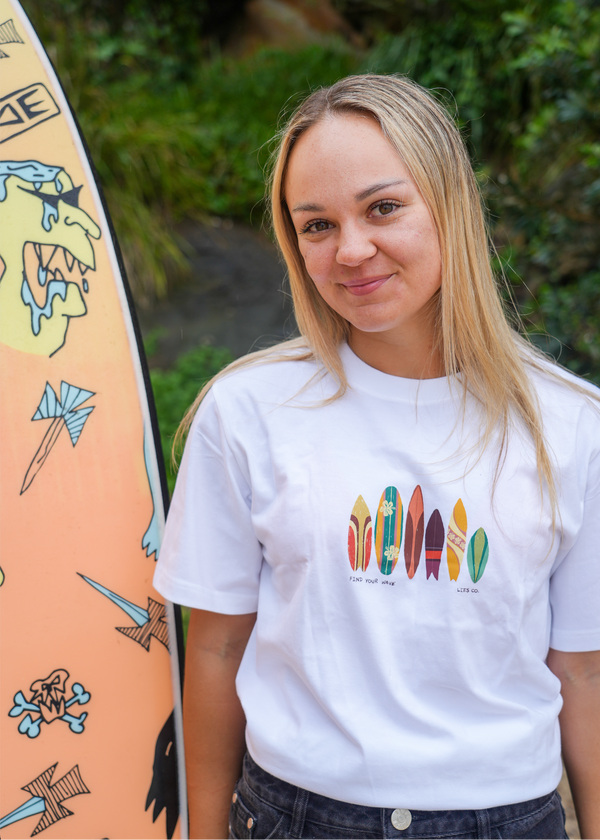 White crew-neck tee with colorful surfboard graphic on the chest, short sleeves