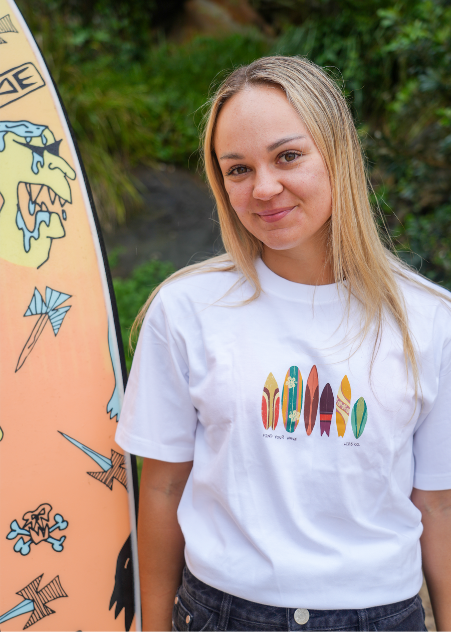 White crew-neck tee with colorful surfboard graphic on the chest, short sleeves