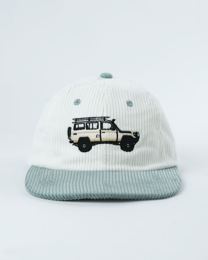 Troopy hat in white corduroy with teal-striped brim and van graphic.