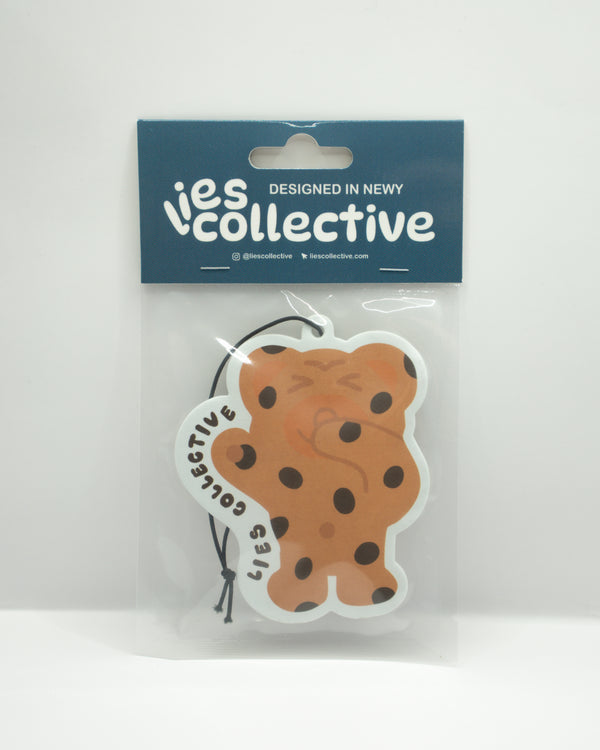 Bear-shaped air freshener with tan and brown face and hanging string