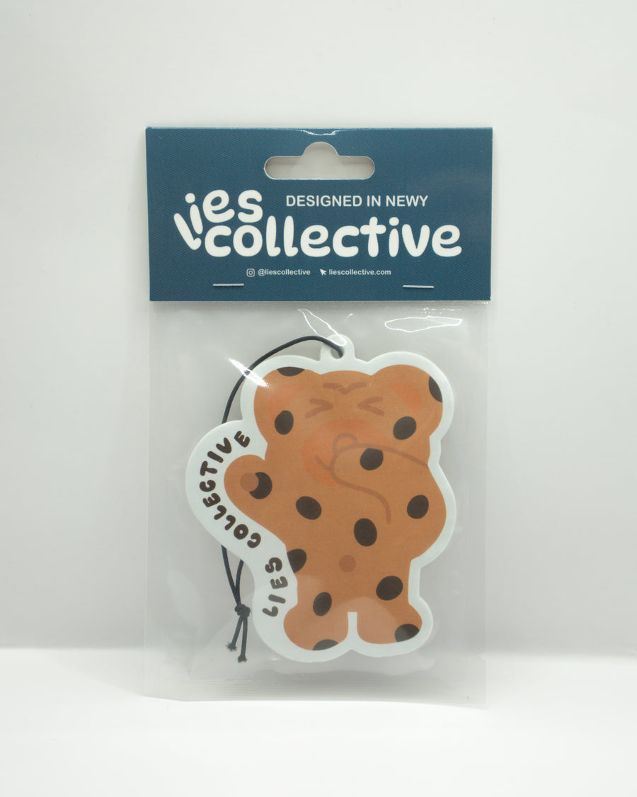 Bear-shaped air freshener with tan and brown face and hanging string